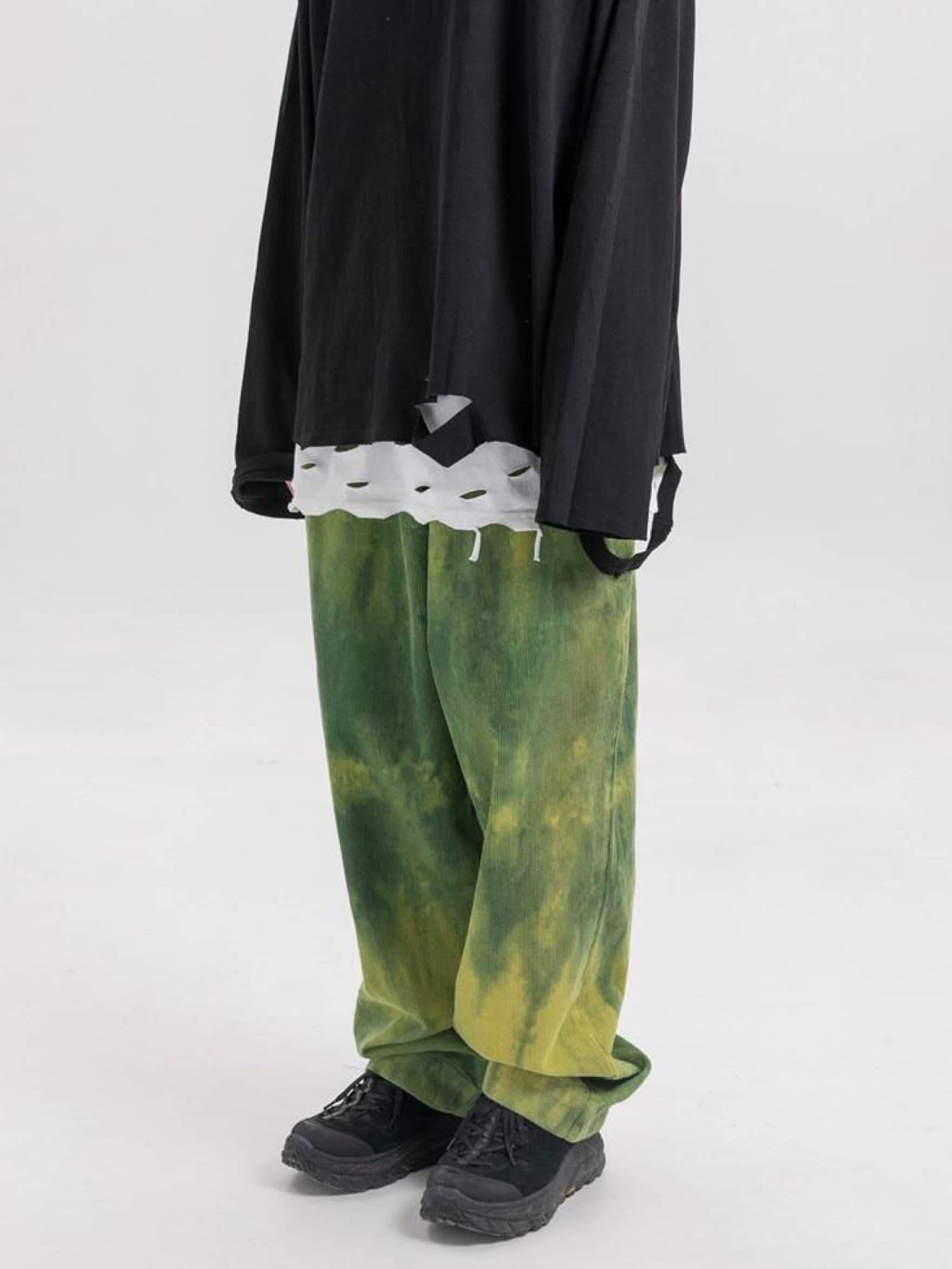 green tie and dye velvet long pants vh studios with made extreme embroidered in white on the top of the left thigh. t has an elastic waist adjustable with a white lace worn