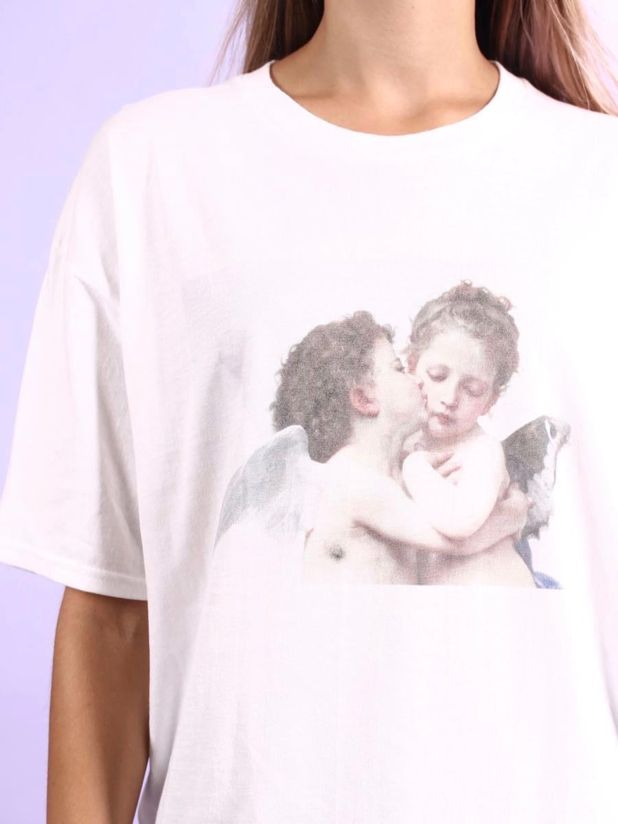 details of the white tshirt with a print of two angels, one kissing the other on the cheek