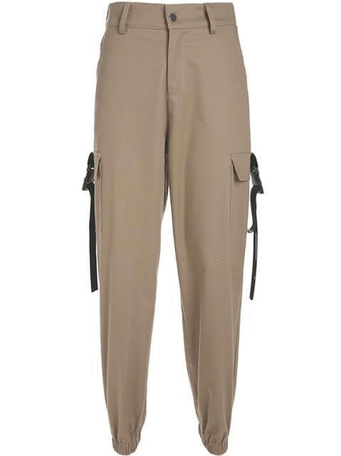 beige high waist cargo pants with two big side pockets closed by a plastic buckle strap