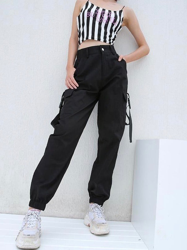 black high waist cargo pants with two big side pockets closed by a plastic buckle strap