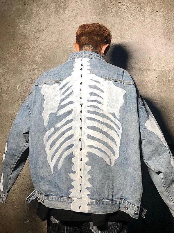 back view of our blue denim jacket with the skeleton painted in white