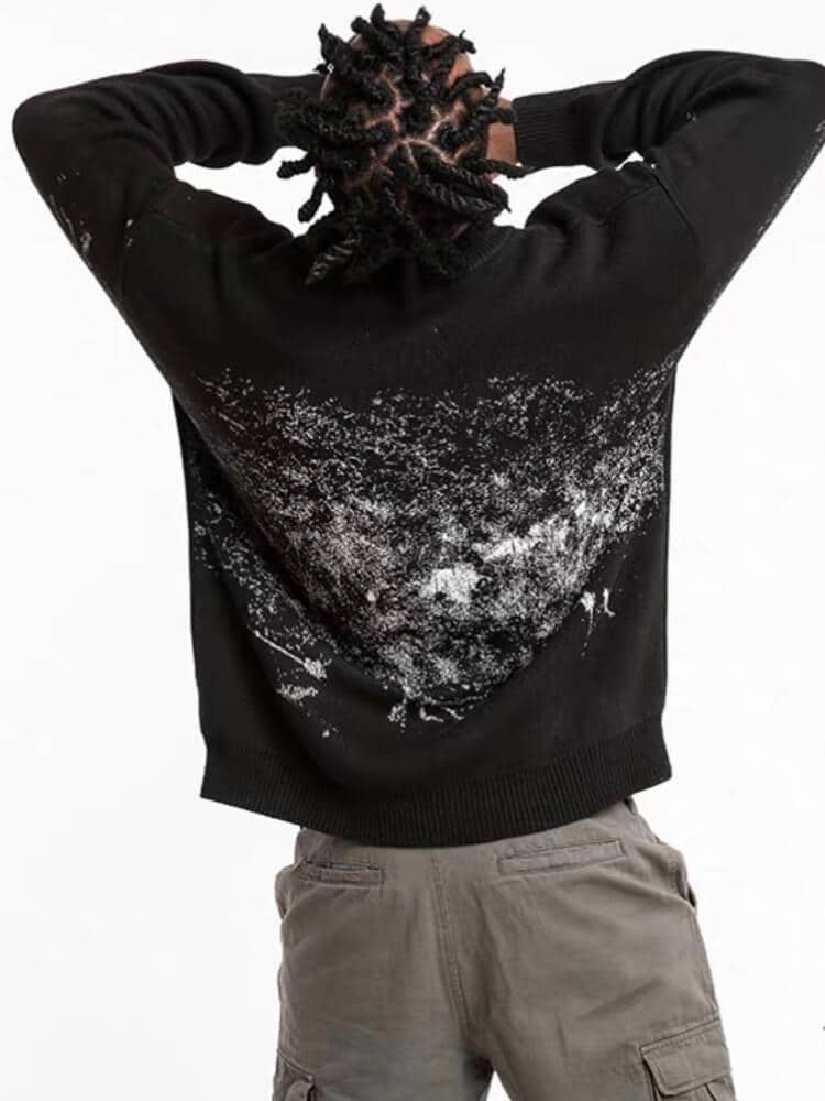 back view of our black sweater with a creepy smiling silhouette shadow printed with the text watch you. On the back there are white brushstrokes