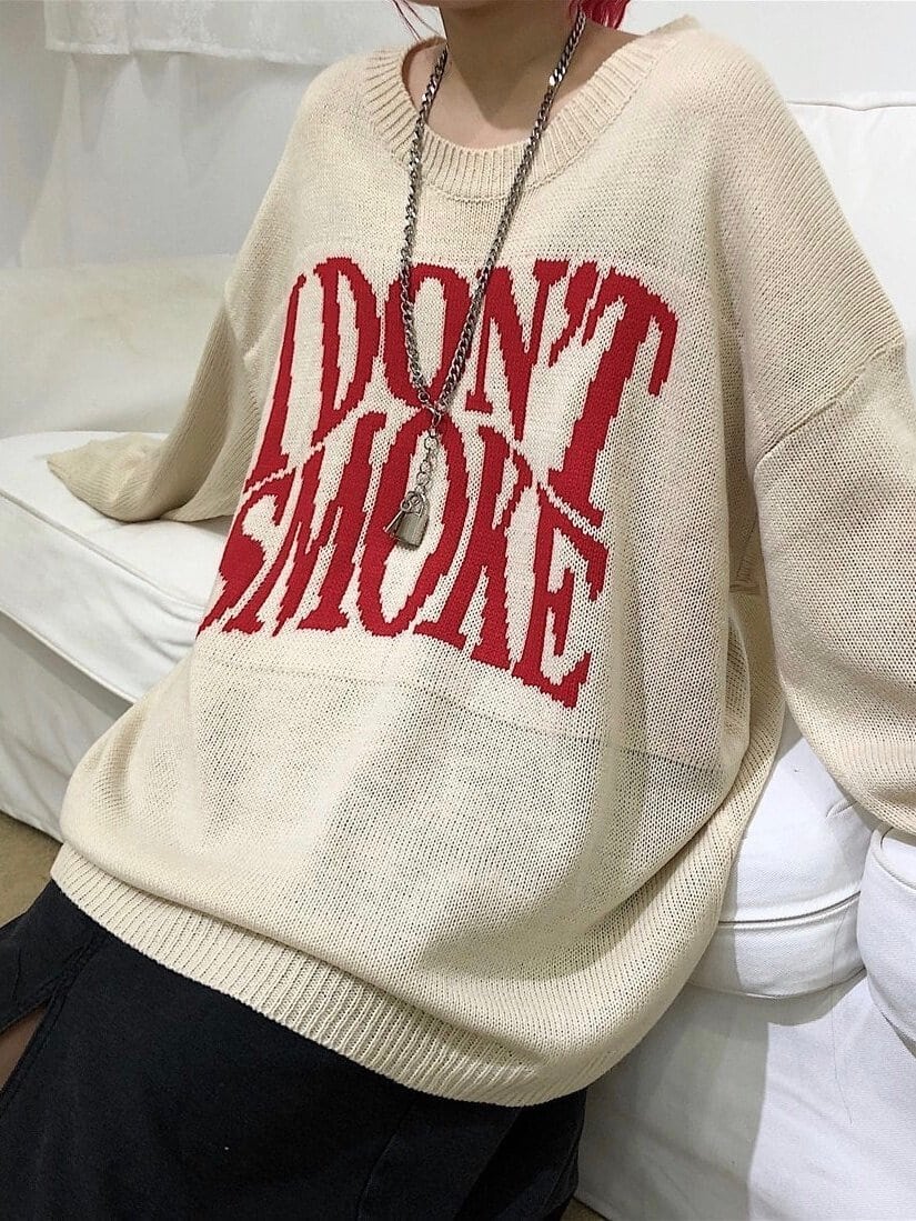 apricot knitter sweater with I don't smoke written in big red letters on the chest